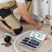 Installer kneels by radiator using pex b crimp rings; labeled case and jar keep sizes sorted for quick, reliable PEX repairs.