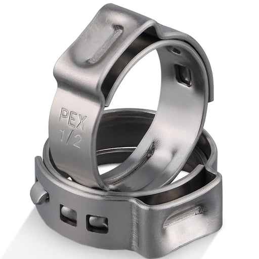 Close-up of 1/2 in PEX clamp rings stacked, smooth 304 metal; adjustable ring clamps set for PEX tubing connections.