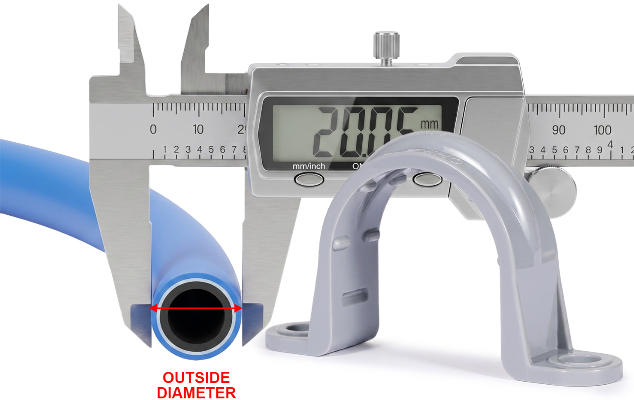 Caliper measuring pipe outside diameter beside a PVC pipe strap